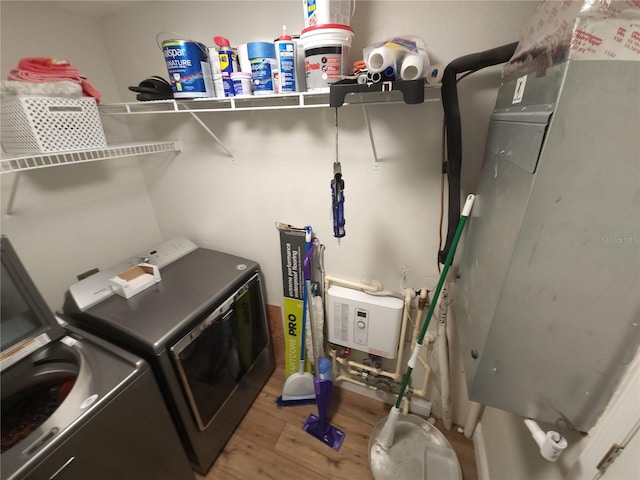 laundry room with wood-type flooring and washer and dryer