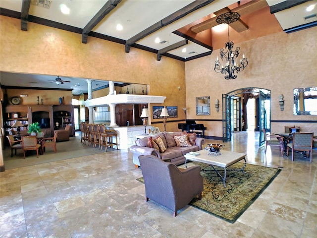 living room with ceiling fan with notable chandelier, a towering ceiling, and beam ceiling