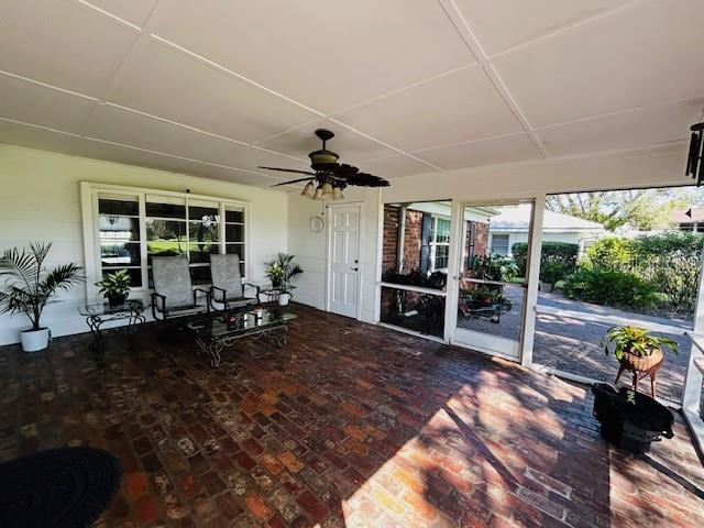 sunroom featuring ceiling fan