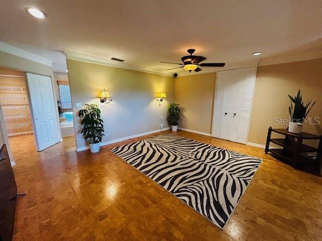 sitting room featuring ceiling fan and crown molding