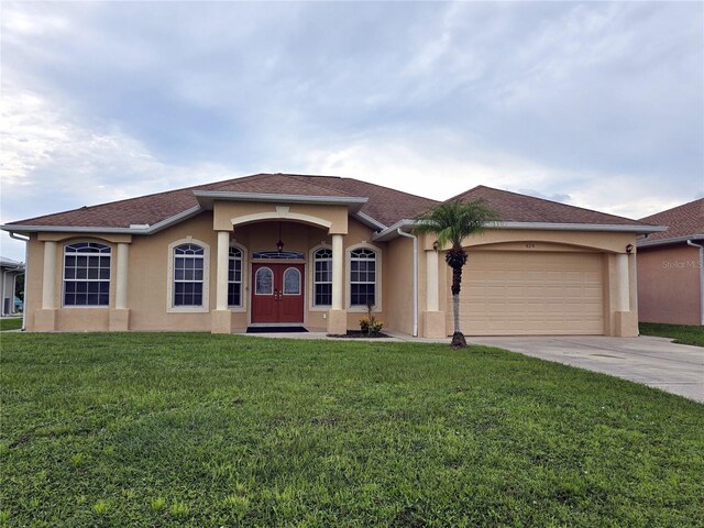 view of front of property with a garage and a front yard