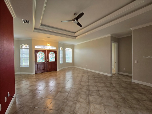 foyer entrance featuring ceiling fan, a raised ceiling, french doors, crown molding, and tile patterned flooring