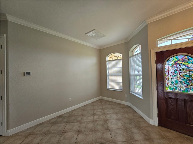 foyer entrance with crown molding and light tile patterned floors