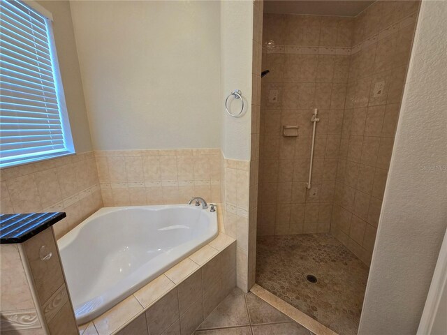 bathroom with plus walk in shower and tile patterned floors