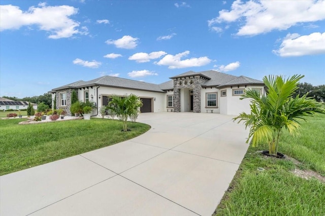 prairie-style home with a garage and a front yard