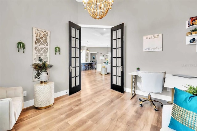 office area featuring french doors, a chandelier, and hardwood / wood-style floors