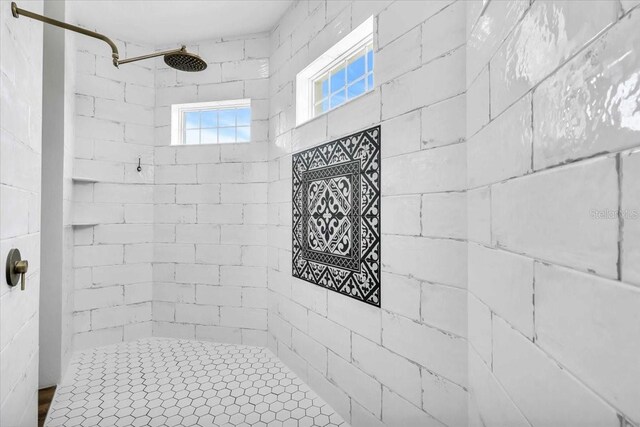 bathroom with tiled shower