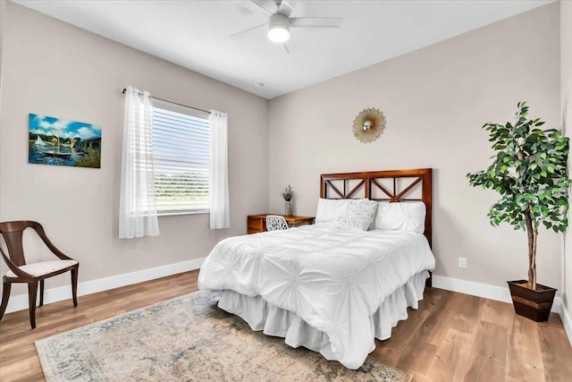 bedroom with ceiling fan and hardwood / wood-style flooring