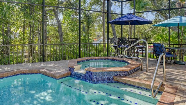 view of swimming pool featuring an in ground hot tub