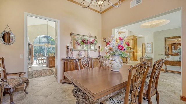 tiled dining space with a notable chandelier and a towering ceiling