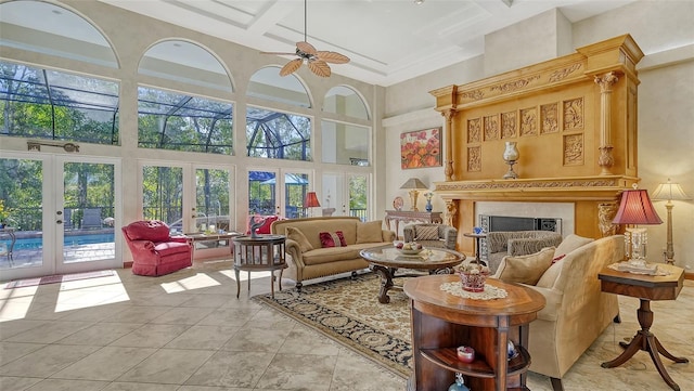 living room featuring a healthy amount of sunlight, a high end fireplace, ceiling fan, and french doors