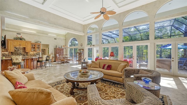 interior space with ceiling fan, light tile patterned flooring, plenty of natural light, and french doors