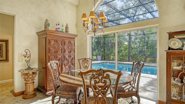 dining space with a chandelier and a high ceiling