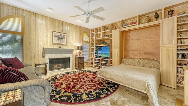 bedroom featuring wooden walls and ceiling fan