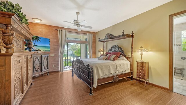 bedroom with wood-type flooring, ceiling fan, access to exterior, and ensuite bathroom