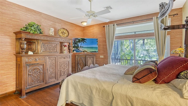 bedroom featuring ceiling fan, hardwood / wood-style floors, and access to exterior