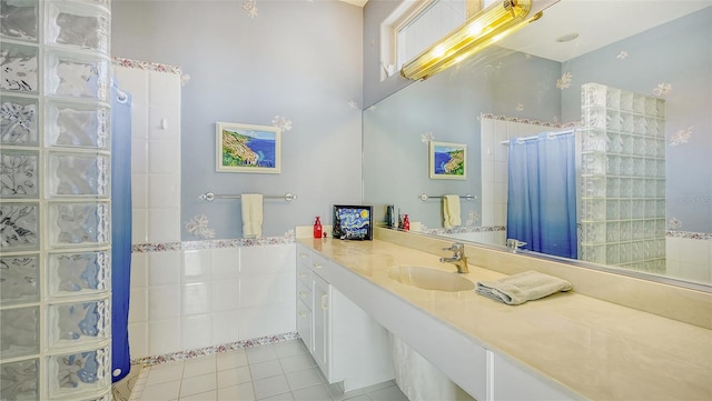 bathroom with tile patterned floors, vanity, and curtained shower