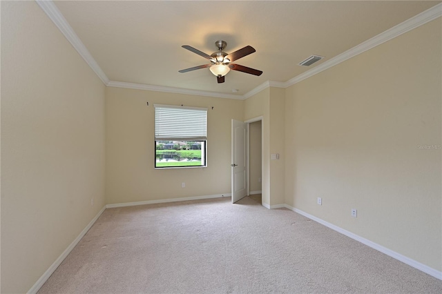 carpeted empty room featuring ornamental molding and ceiling fan