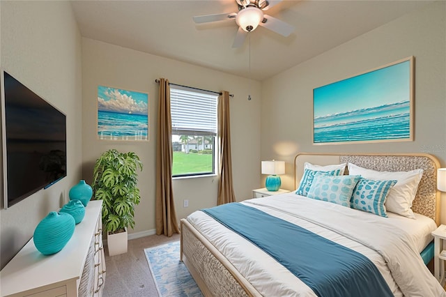 bedroom with ceiling fan and light colored carpet