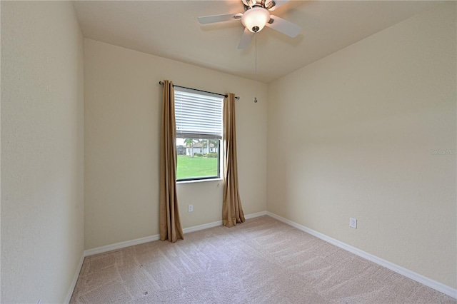 carpeted empty room featuring ceiling fan