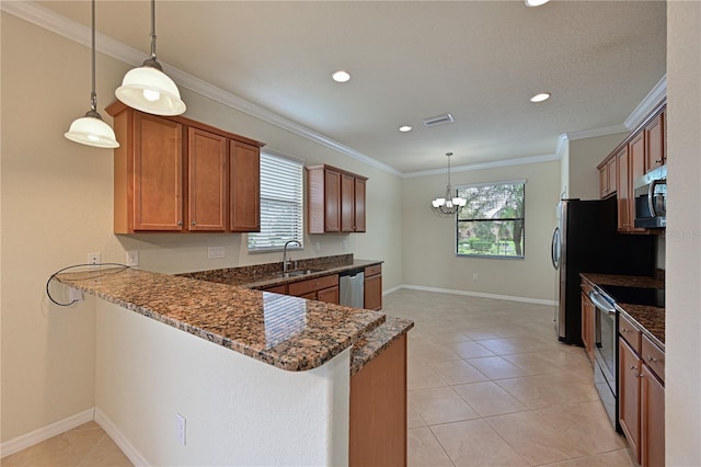 kitchen featuring stainless steel appliances, kitchen peninsula, and a healthy amount of sunlight