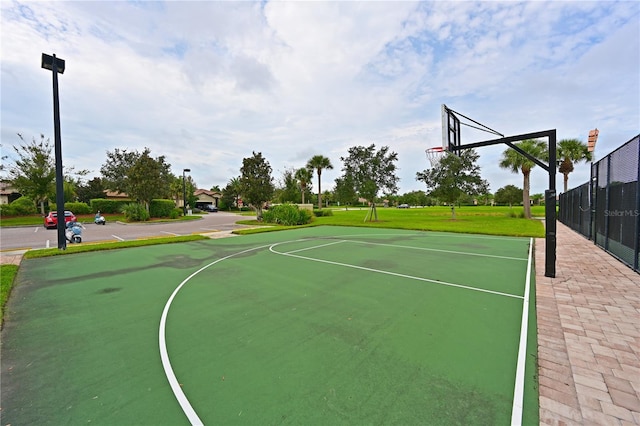 view of sport court featuring a lawn