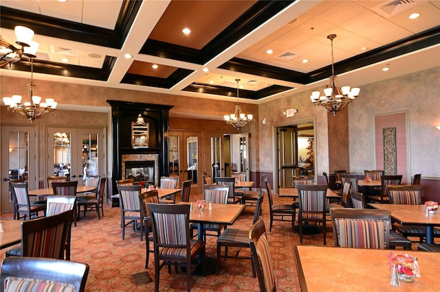 dining area with a notable chandelier, beam ceiling, and coffered ceiling