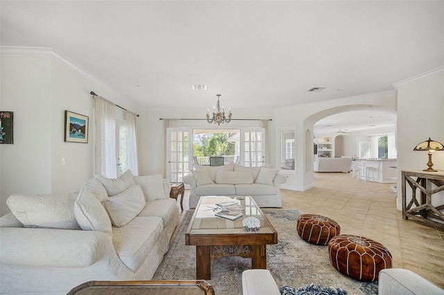 tiled living room featuring a notable chandelier and ornamental molding