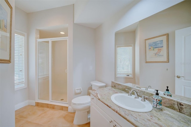 bathroom with vanity, toilet, a shower with door, and tile patterned floors