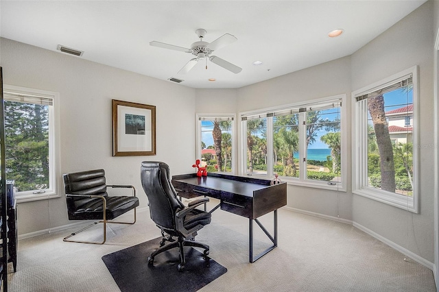 home office featuring ceiling fan and light colored carpet