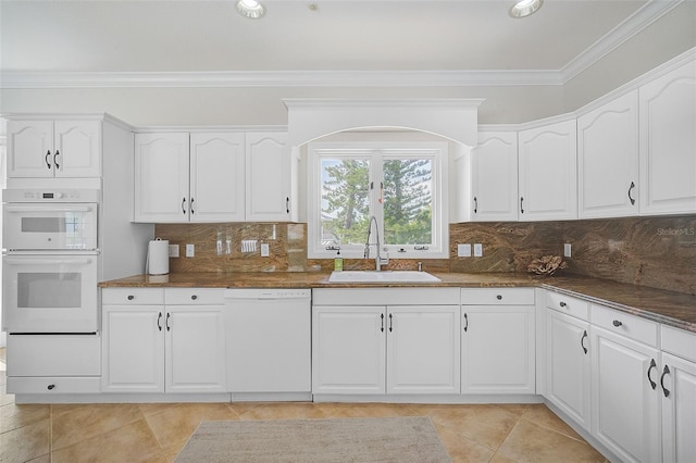 kitchen with white cabinets, white appliances, tasteful backsplash, and sink