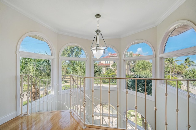 interior space featuring crown molding and light hardwood / wood-style floors