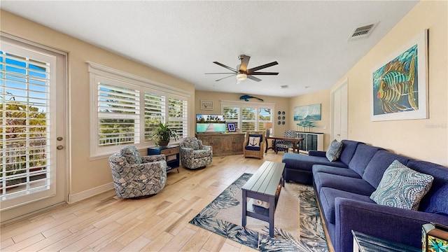 living room with light hardwood / wood-style floors and ceiling fan