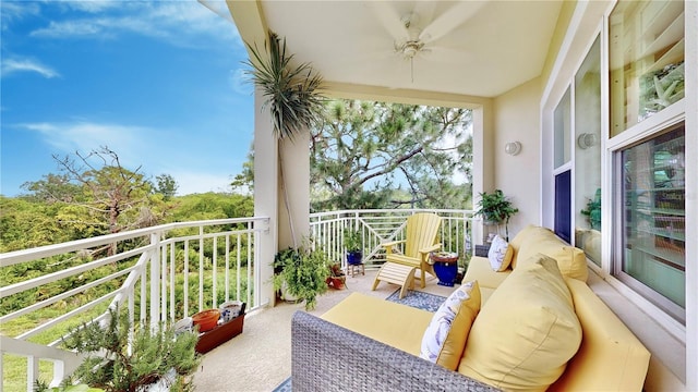 balcony featuring an outdoor living space and ceiling fan