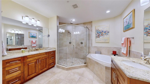 bathroom featuring shower with separate bathtub, vanity, and tile patterned floors