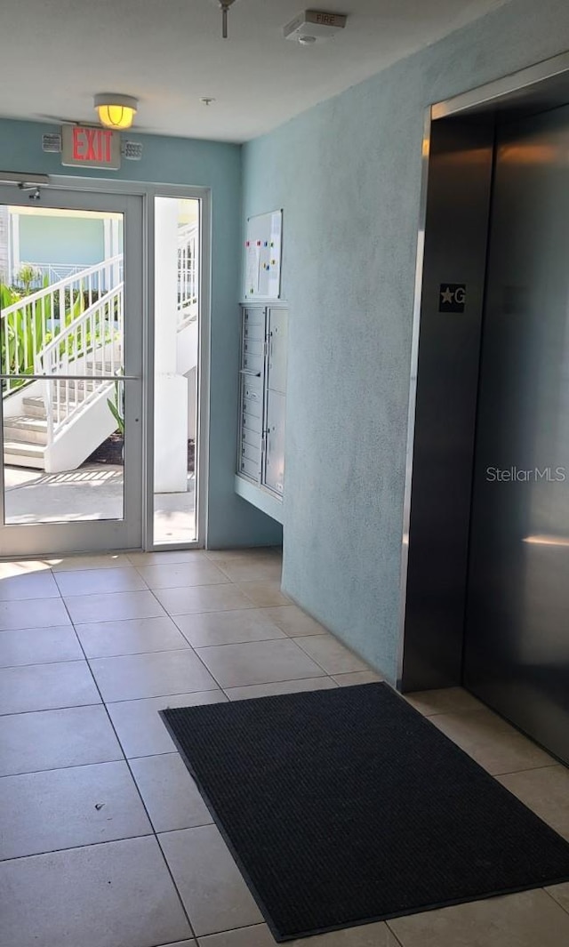 interior space featuring light tile patterned flooring and elevator