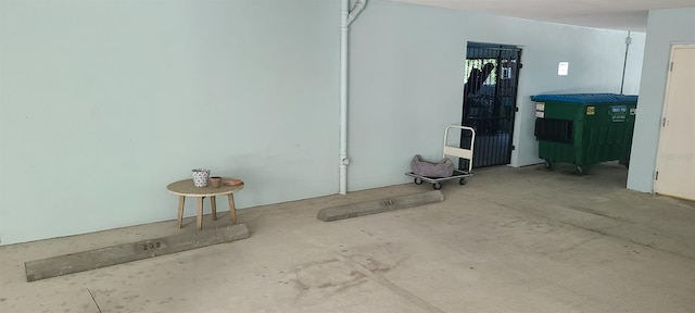 unfurnished room featuring concrete floors