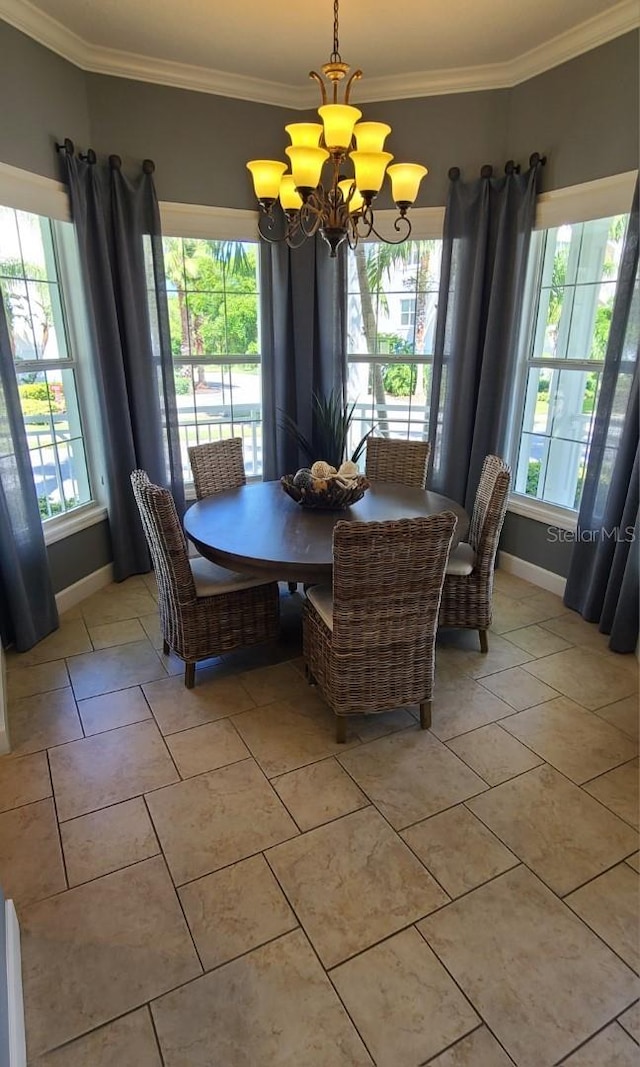 tiled dining room featuring a chandelier and crown molding