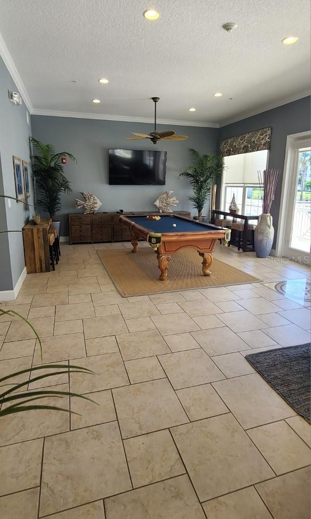 rec room featuring ceiling fan, light tile patterned floors, a textured ceiling, pool table, and crown molding