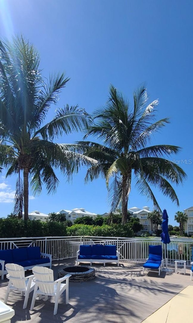 view of swimming pool with a patio and a fire pit