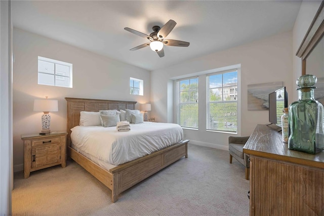 bedroom with light carpet and ceiling fan