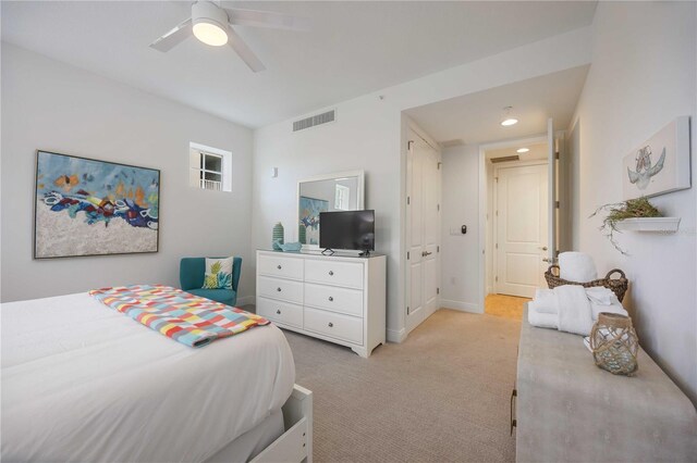 bedroom featuring ceiling fan and light colored carpet