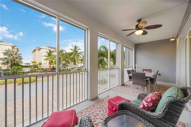 sunroom featuring ceiling fan