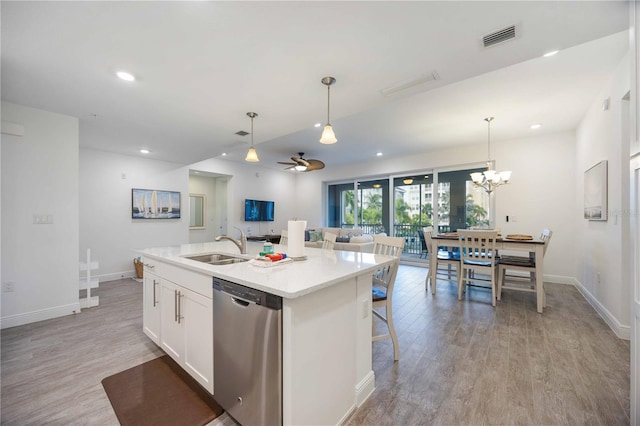 kitchen featuring dishwasher, light hardwood / wood-style floors, sink, an island with sink, and white cabinetry