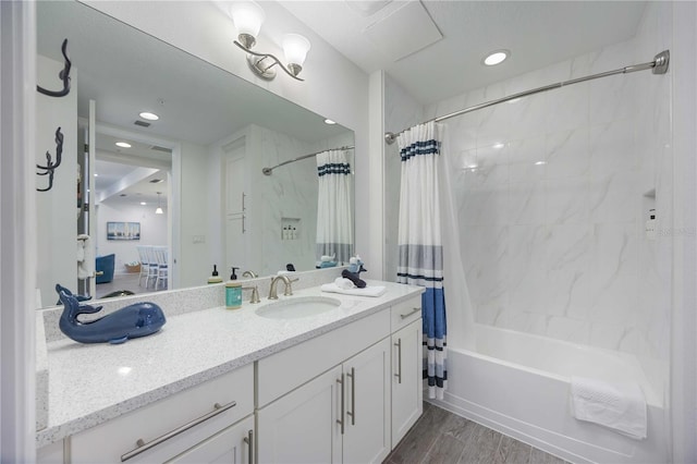 bathroom featuring vanity, shower / bath combo with shower curtain, and hardwood / wood-style flooring