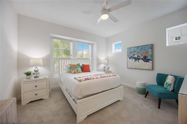 bedroom featuring ceiling fan and light carpet