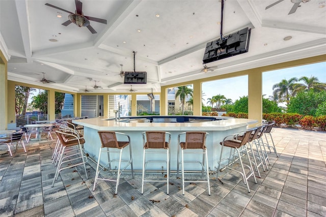 interior space featuring exterior bar and ceiling fan