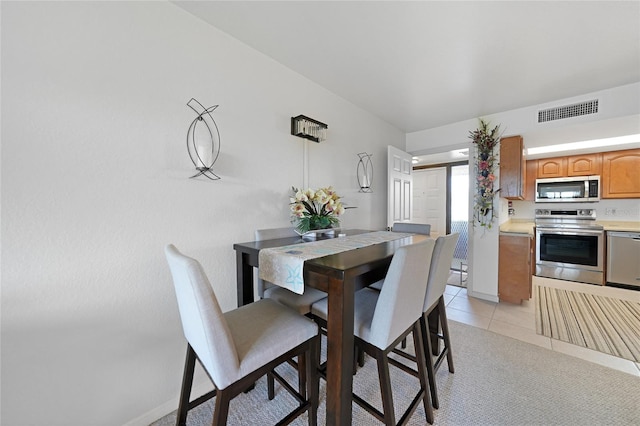 dining area featuring light tile patterned floors