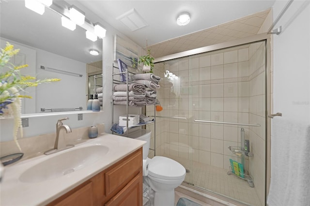 bathroom with vanity, toilet, and an enclosed shower