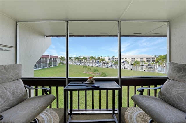 sunroom / solarium with a water view and a wealth of natural light